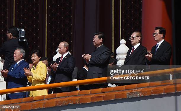 China's President Xi Jinping applauds as he stands with former Chinese presidents Jiang Zemin and Hu Jintao , Kazakhstan President Nursultan...