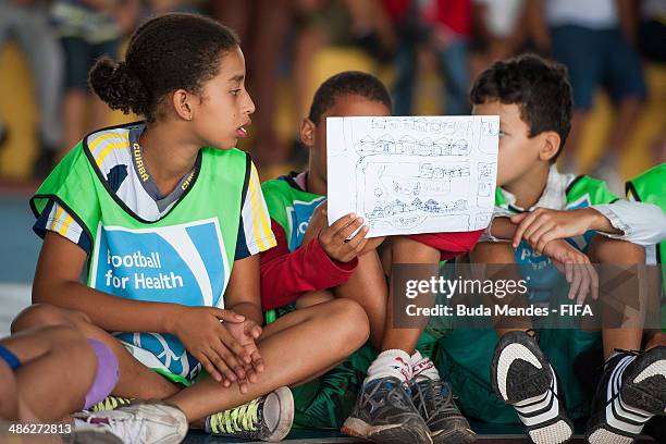 Kids practice exercises during visit a FIFA 11 for Health Program as part of the 2014 FIFA World Cup Host City Tour on April 23, 2014 in Cuiaba,...