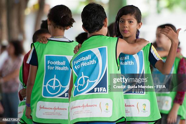 Kids practice exercises during visit a FIFA 11 for Health Program as part of the 2014 FIFA World Cup Host City Tour on April 23, 2014 in Cuiaba,...