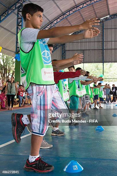 Kids practice exercises during visit a FIFA 11 for Health Program as part of the 2014 FIFA World Cup Host City Tour on April 23, 2014 in Cuiaba,...