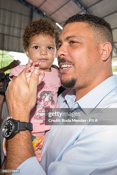 Member Ronaldo Luis Nazario greets a kid during visit the FIFA 11 for Health Program as part of the 2014 FIFA World Cup Host City Tour on April 23,...