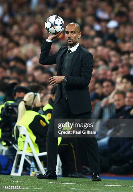 Josep Guardiola, coach of Bayern Muenchen throws the ball back during the UEFA Champions League semi-final first leg match between Real Madrid and FC...