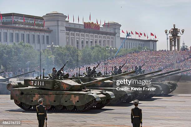 Chinese soldiers ride in tanks as they pass in front of Tiananmen Square and the Forbidden City during a military parade on September 3, 2015 in...