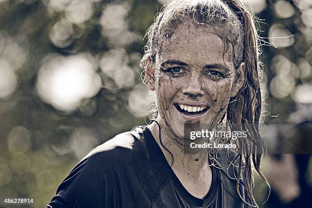 close up of happy woman covered by mud - happy faces stockfoto's en -beelden