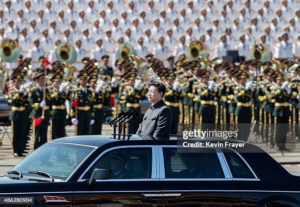 Chinese president and leader of the Communist Party Xi Jinping rides in an open top car in front of Tiananmen Square and the Forbidden City during a...