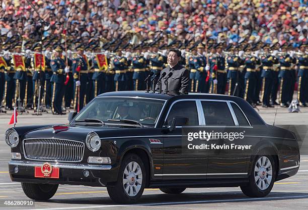 Chinese president and leader of the Communist Party Xi Jinping rides in an open top car in front of Tiananmen Square and the Forbidden City during a...