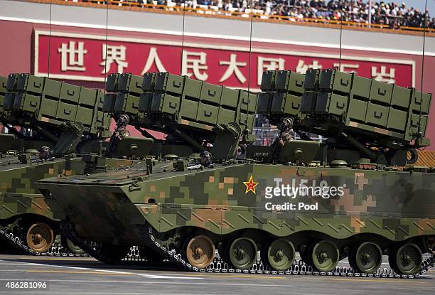 Military vehicles with anti-tank missiles, drive past the Tiananmen Gate during a military parade to mark the 70th anniversary of the end of World...
