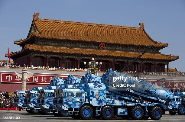 Military vehicles carry DF-10 ship launched cruise missiles, drive past the Tiananmen Gate during a military parade to mark the 70th anniversary of...