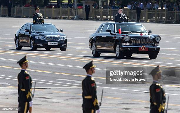 Chinese president and leader of the Communist Party Xi Jinping, top right, rides in an open top car in front of Tiananmen Square and the Forbidden...