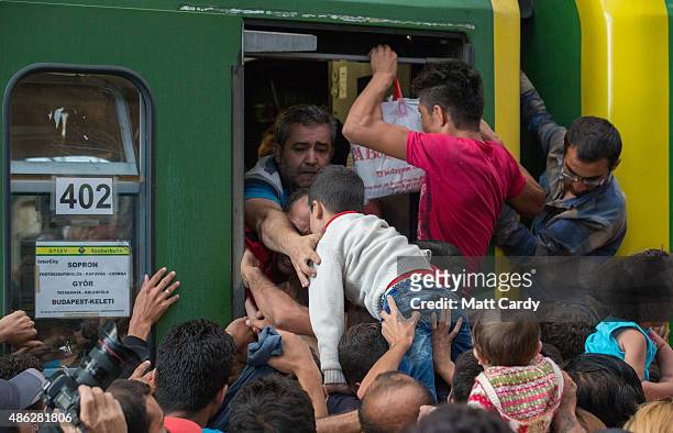 Migrants board a train in Keleti station after it was reopened this morning in central Budapest on September 3, 2015 in Budapest, Hungary. Although...
