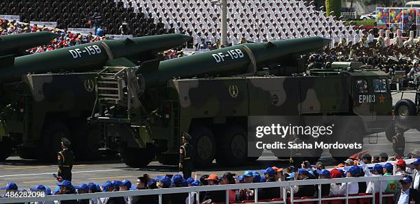 Military vehicles drive past the Tiananmen Gate during a military parade to mark the 70th anniversary of the end of World War Two on September 3,...