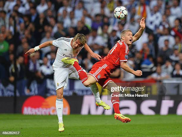 Bastian Schweinsteiger of Bayern Muenchen is challenged by Fabio Coentrao of Real Madrid during the UEFA Champions League semi-final first leg match...