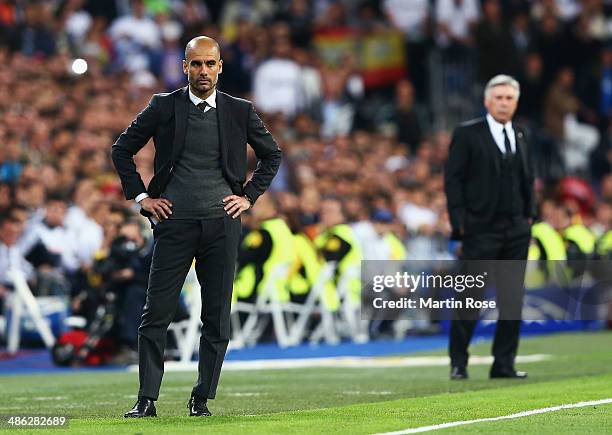 Josep Guardiola, coach of Bayern Muenchen looks dejected with Carlo Ancelotti, coach of Real Madrid during the UEFA Champions League semi-final first...