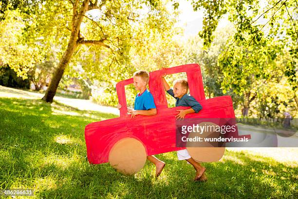 children playing with cardboard car - cardboard car stock pictures, royalty-free photos & images