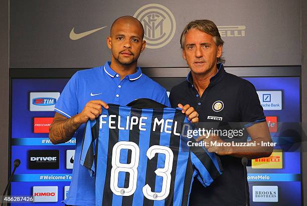 Felipe Melo new signing for FC Internazionale Milano pose with the club shirt with FC Internazionale Milano coach Roberto Mancini during a press...