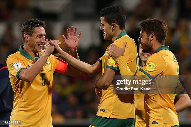 Mark Milligan of Australia congratulates Tom Rogic after scoring a goal during the 2018 FIFA World Cup Qualification match between the Australian...