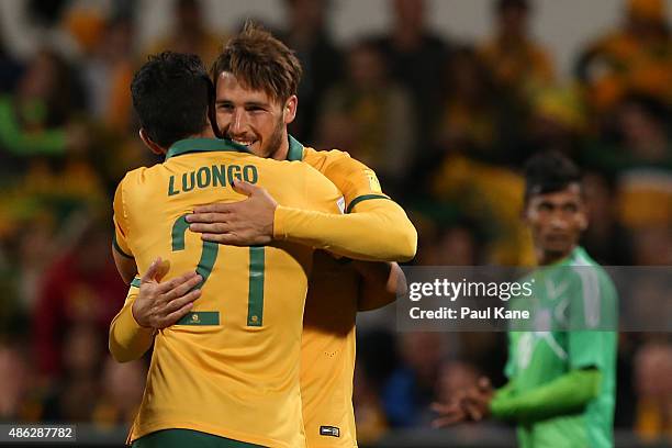 Massimo Luongo congratulates Mathew Leckie of Australia after scoring during the 2018 FIFA World Cup Qualification match between the Australian...