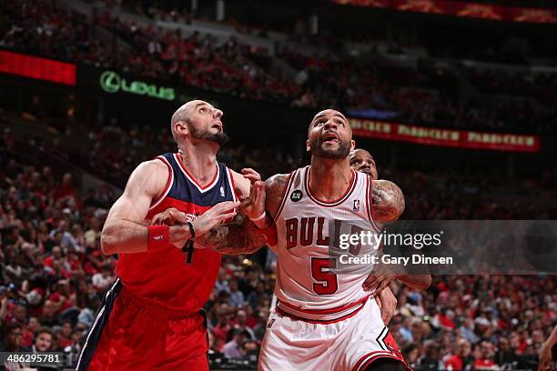 Marcin Gortat of the Washington Wizards battles for position against Carlos Boozer of the Chicago Bulls during Game 1 of the Eastern Conference...