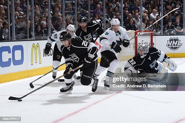 Slava Voynov of the Los Angeles Kings skates with the puck against Tommy Wingels and Joe Pavelski of the San Jose Sharks in Game Three of the First...