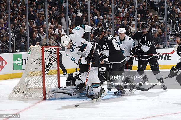 Brent Burns of the San Jose Sharks skates in the crease against Jake Muzzin of the Los Angeles Kings in Game Three of the First Round of the 2014...