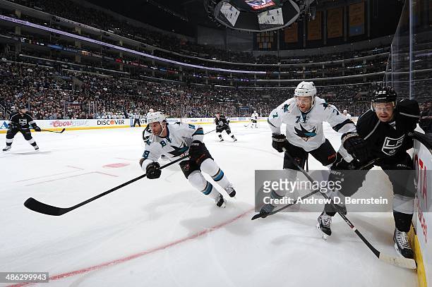 Mike Brown and Brad Stuart of the San Jose Sharks skate against Trevor Lewis of the Los Angeles Kings in Game Three of the First Round of the 2014...
