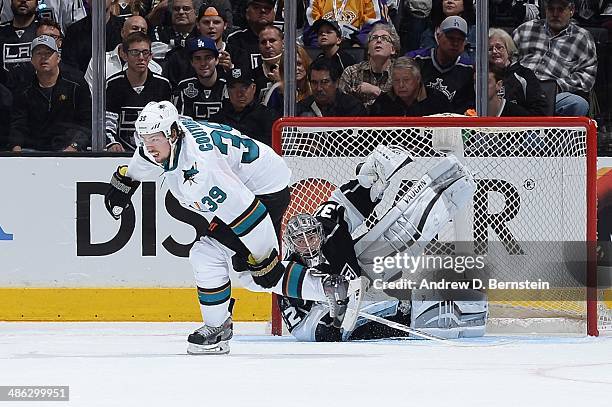 Jonathan Quick of the Los Angeles Kings makes a save against Logan Couture of the San Jose Sharks the San Jose Sharks against the Los Angeles Kings...