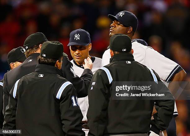 Home plate umpire Gerry Davis checks out a substance on the neck of Michael Pineda of the New York Yankees before throwing him out of the game in the...