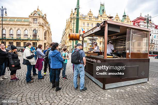 people waiting in line to buy famous trdelnik, prague - trdelník stock pictures, royalty-free photos & images