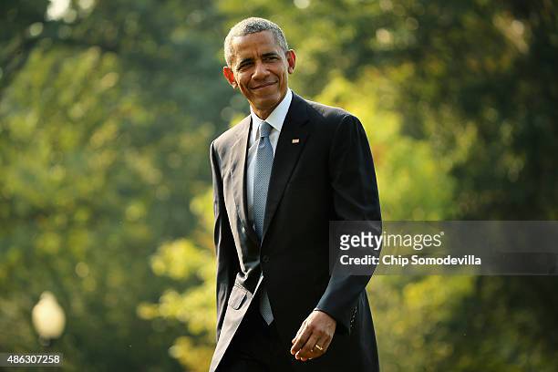 President Barack Obama waves to reporters after returning to the White House on board Marine One September 3, 2015 in Washington, DC. Obama spent...