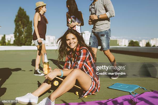group of friends drinking beer on the rooftop - city to surf stock pictures, royalty-free photos & images