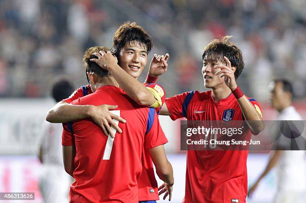 Son Heung-Min of South Korea celebrates with Ki Sung-Yueng after scoring a goal during the 2018 FIFA World Cup Qualifier Round 2 - Group G match...