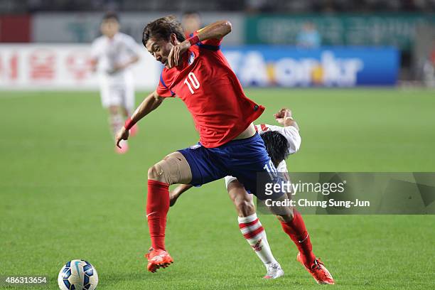 Hwang Ui-Jo of South Korea compete for the ball with Souksavath Moukda of Laos during the 2018 FIFA World Cup Qualifier Round 2 - Group G match...