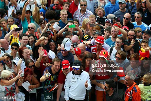 Fernando Alonso of Spain and McLaren Honda poses with fans in the pit lane during previews to the Formula One Grand Prix of Italy at Autodromo di...