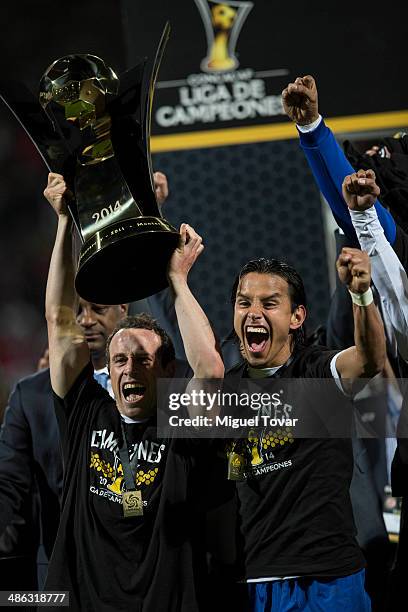 Gerardo Torrado and Gerardo Flores hold the trophy after winning the leg 2 of the final match between Cruz Azul and Toluca as part of the CONCACAF...