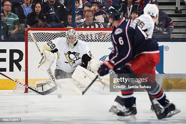 Goaltender Marc-Andre Fleury of the Pittsburgh Penguins follows a shot taken by Nikita Nikitin of the Columbus Blue Jackets during the second period...