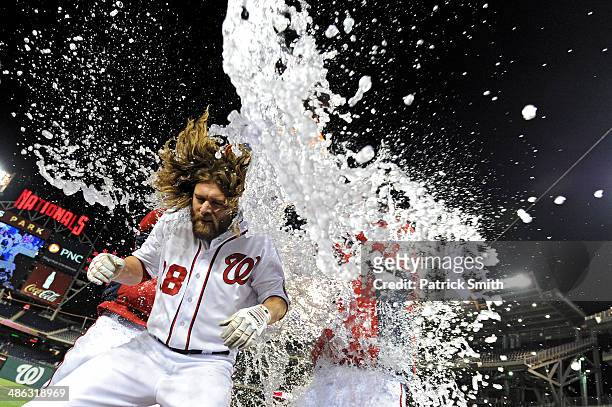 Jayson Werth of the Washington Nationals is doused with water by teammates, after he hit an RBI double to score two runs to tie the game in the ninth...