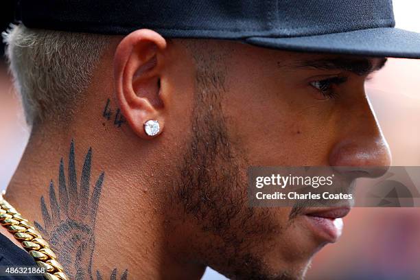 Lewis Hamilton of Great Britain and Mercedes GP speaks with members of the media in the paddock during previews to the Formula One Grand Prix of...