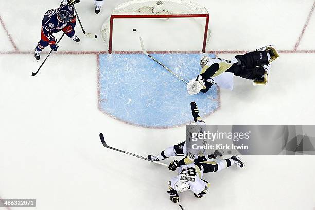 Cam Atkinson of the Columbus Blue Jackets watches as Brandon Dubinsky of the Columbus Blue Jackets shoots the puck past Sidney Crosby, Kris Letang,...
