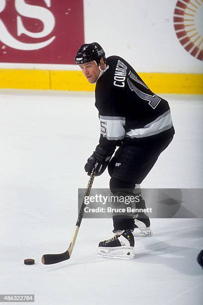 Pat Conacher of the Los Angeles Kings skates with the puck during an NHL game against the Florida Panthers on November 26, 1995 at the Miami Arena in...