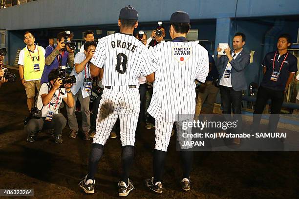 Starting pitcher Sena Sato and Outfielder Louis Okoye of Japan pose for a photograph after winning in the super round game between Japan v Canada...