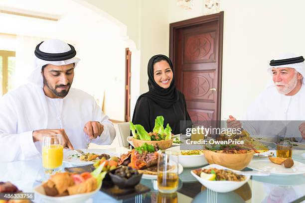 arabic family enjoying lunch - ramadan celebration stock pictures, royalty-free photos & images