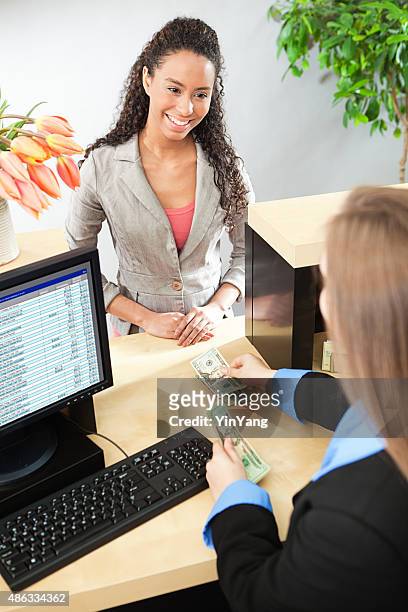bank teller and customer banking transaction in retail bank counter - bank teller and customer stock pictures, royalty-free photos & images