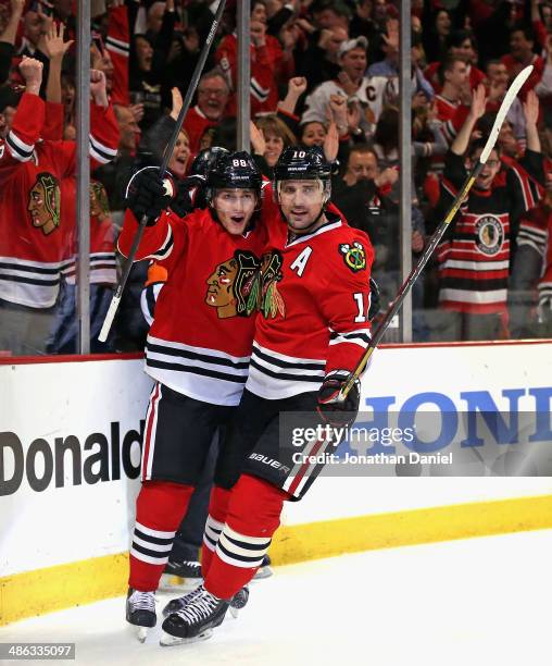 Patrick Kane and Patrick Sharp of the Chicago Blackhawks celebrate a second period goal by Kane against the St. Louis Blues in Game Four of the First...