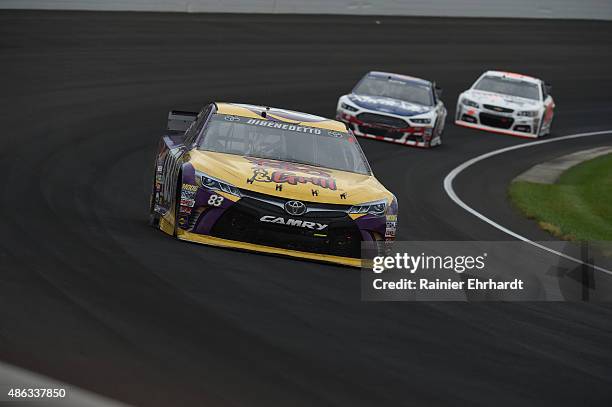 Matt DiBenedetto, driver of the VooDoo BBQ & Grill Toyota, races during the NASCAR Sprint Cup Series Crown Royal Presents the Jeff Kyle 400 at the...