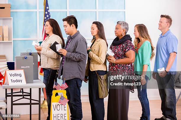 american voters stand in line to cast ballots. november elections. - voting line stock pictures, royalty-free photos & images