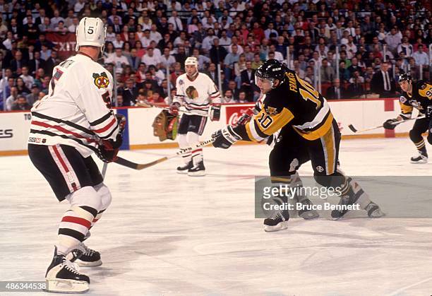Ron Francis of the Pittsburgh Penguins dumps the puck into the offensive zone during Game 4 of the 1992 Stanley Cup Finals against the Chicago...