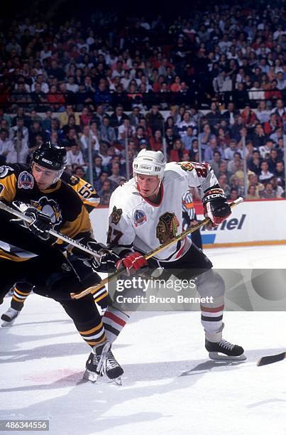 Jeremy Roenick of the Chicago Blackhawks and Ron Francis of the Pittsburgh Penguins tie eachother up after the face-off during Game 4 of the 1992...