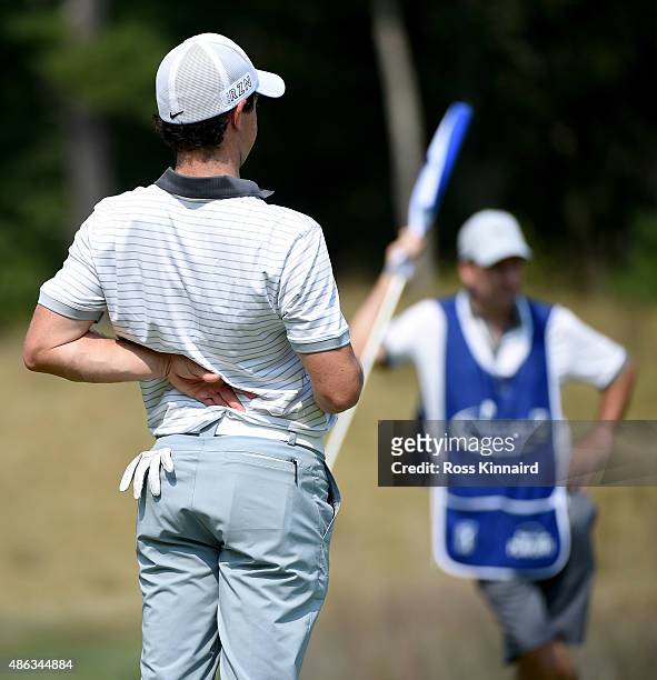 Rory McIlroy of Northern Ireland stretches his backduring the pro-am event prior to the Deutsche Bank Championship at TPC Boston on September 3, 2015...