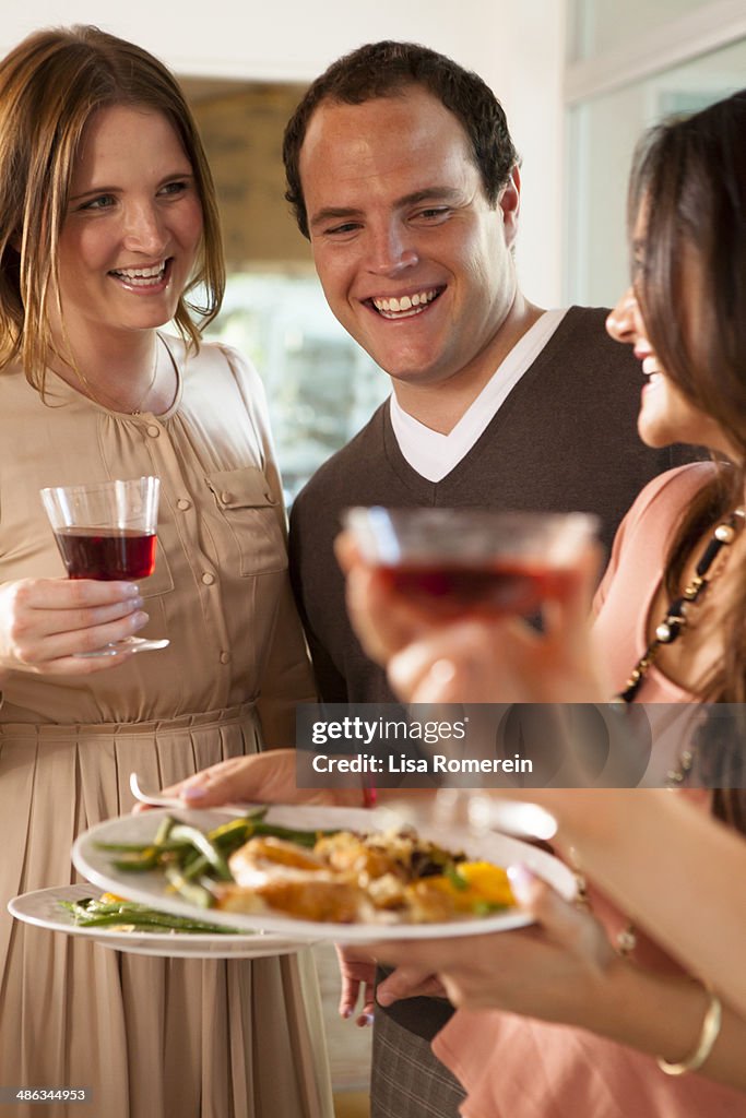 Party guests socialize at holiday dinner party