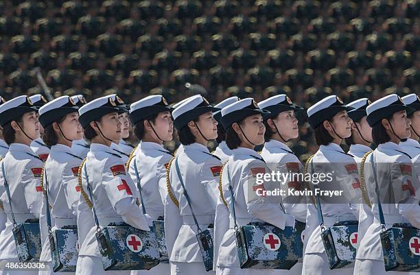 Female Chinese soldiers of the medical corps ride in trucks as they pass in front of Tiananmen Square and the Forbidden City during a military parade...